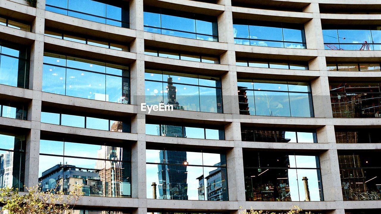 Reflection of cityscape on glass building