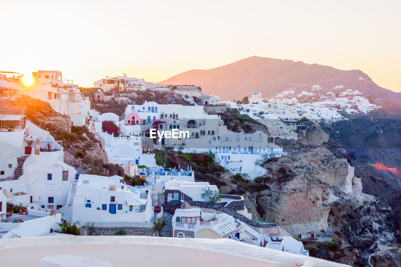 Traditional white cave houses on a cliff on the island santorini, cyclades, greece