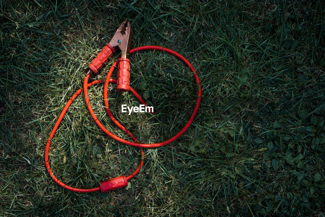 High angle view of jump start cable on field