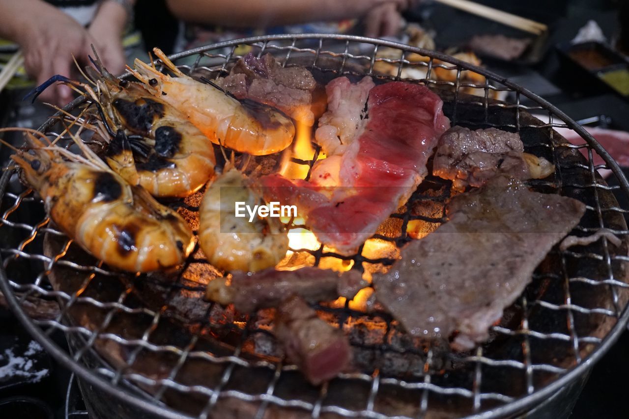 CLOSE-UP OF MEAT ON BARBECUE