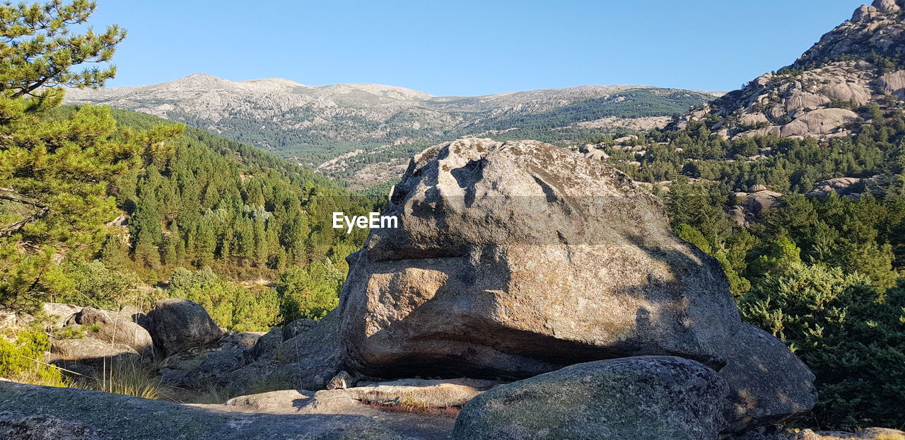 PANORAMIC SHOT OF ROCKS AGAINST SKY