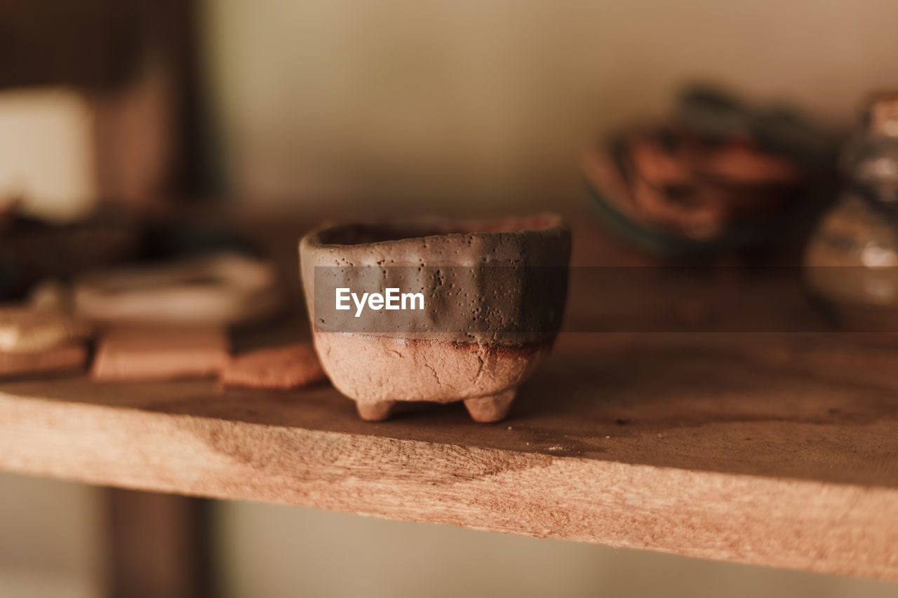 Close-up of old tea cup on table