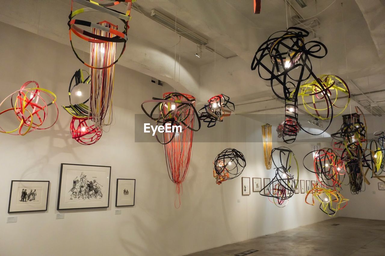 LOW ANGLE VIEW OF LANTERNS HANGING ON CEILING