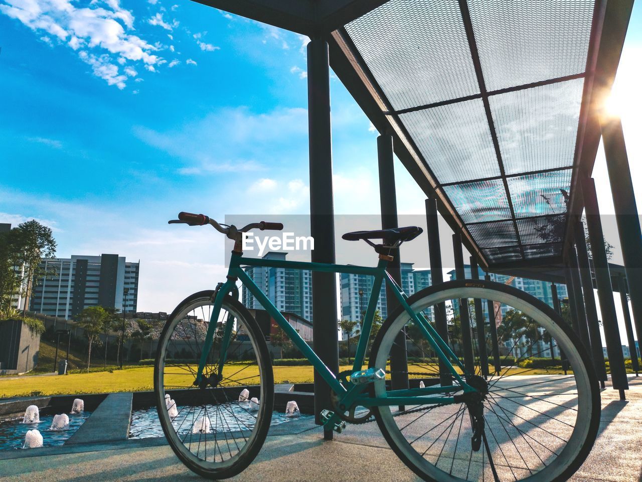 LOW ANGLE VIEW OF BICYCLE AGAINST BUILDING