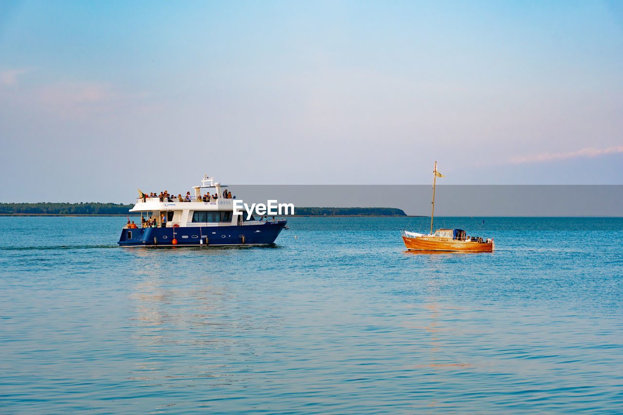 NAUTICAL VESSEL SAILING IN SEA AGAINST SKY