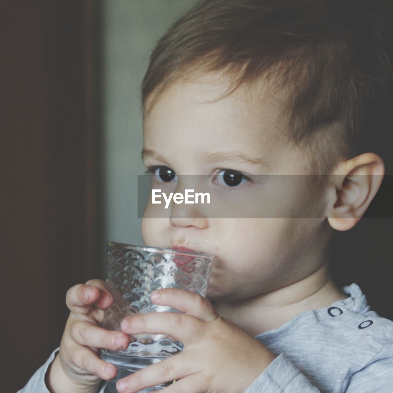 Close-up of cute baby boy drinking