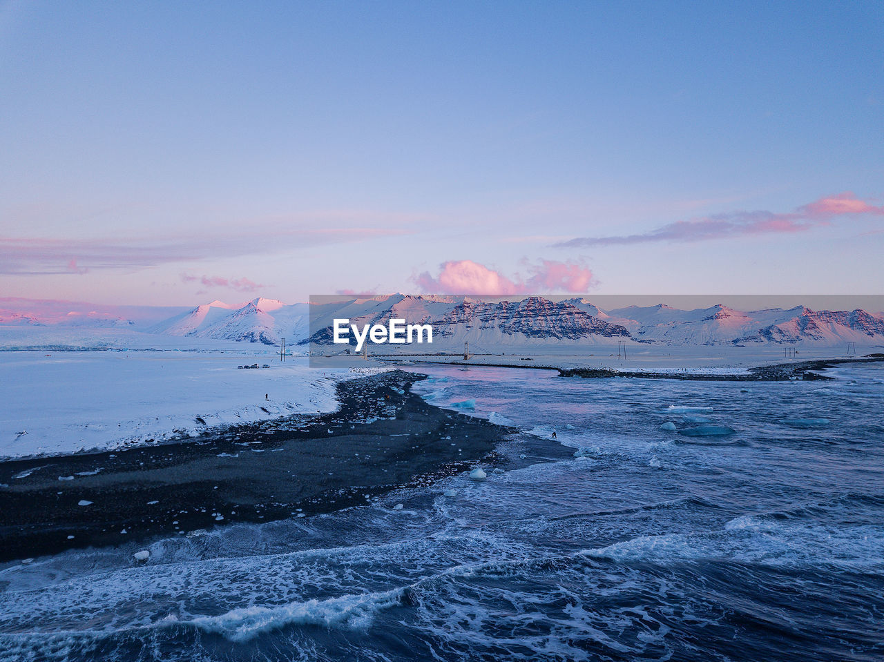 FROZEN SEA AGAINST SKY DURING WINTER
