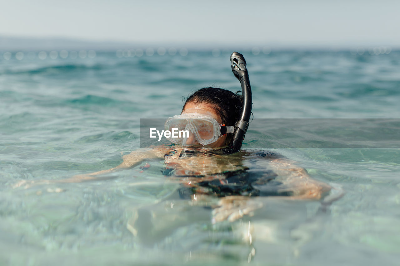 Portrait of woman swimming in sea