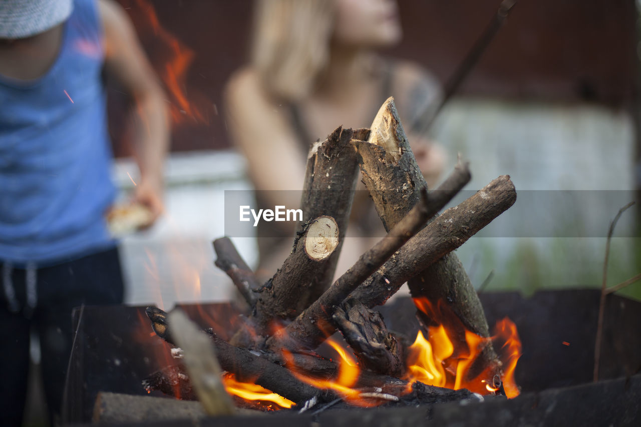 midsection of man preparing food on barbecue grill