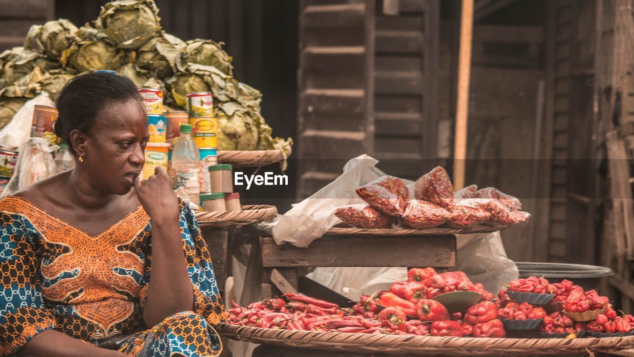 MAN HOLDING FOOD FOR SALE IN MARKET