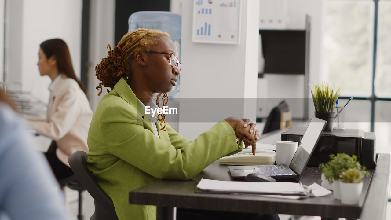 side view of business colleagues working at desk in office