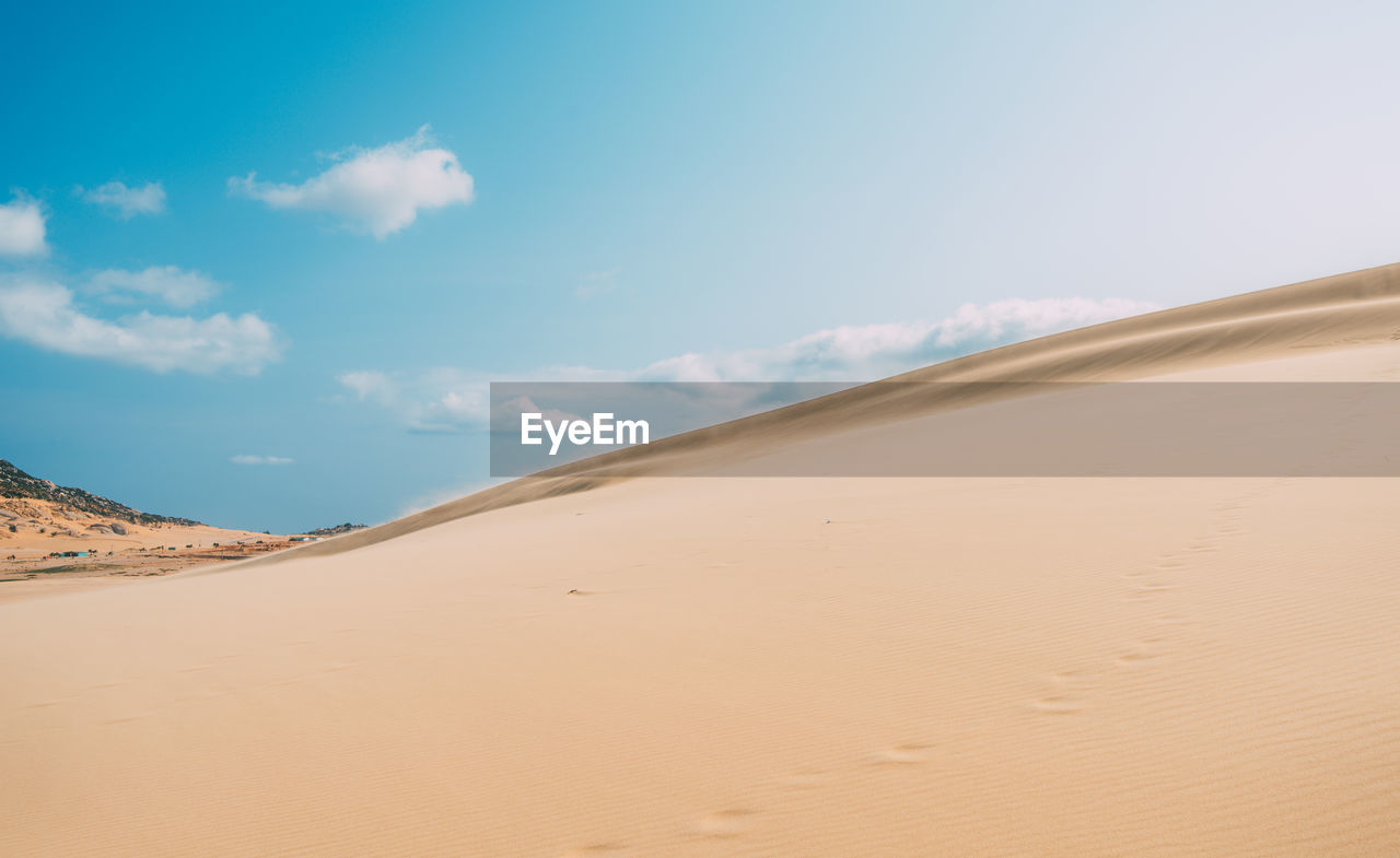 SCENIC VIEW OF SAND DUNES AGAINST SKY
