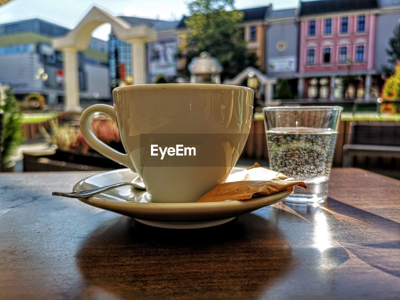 CLOSE-UP OF COFFEE CUP ON TABLE IN CAFE