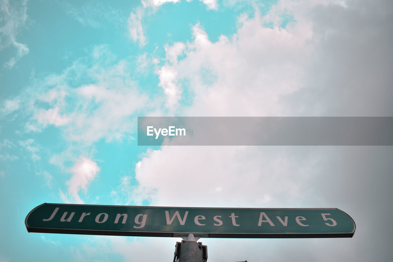 Low angle view of road sign against sky