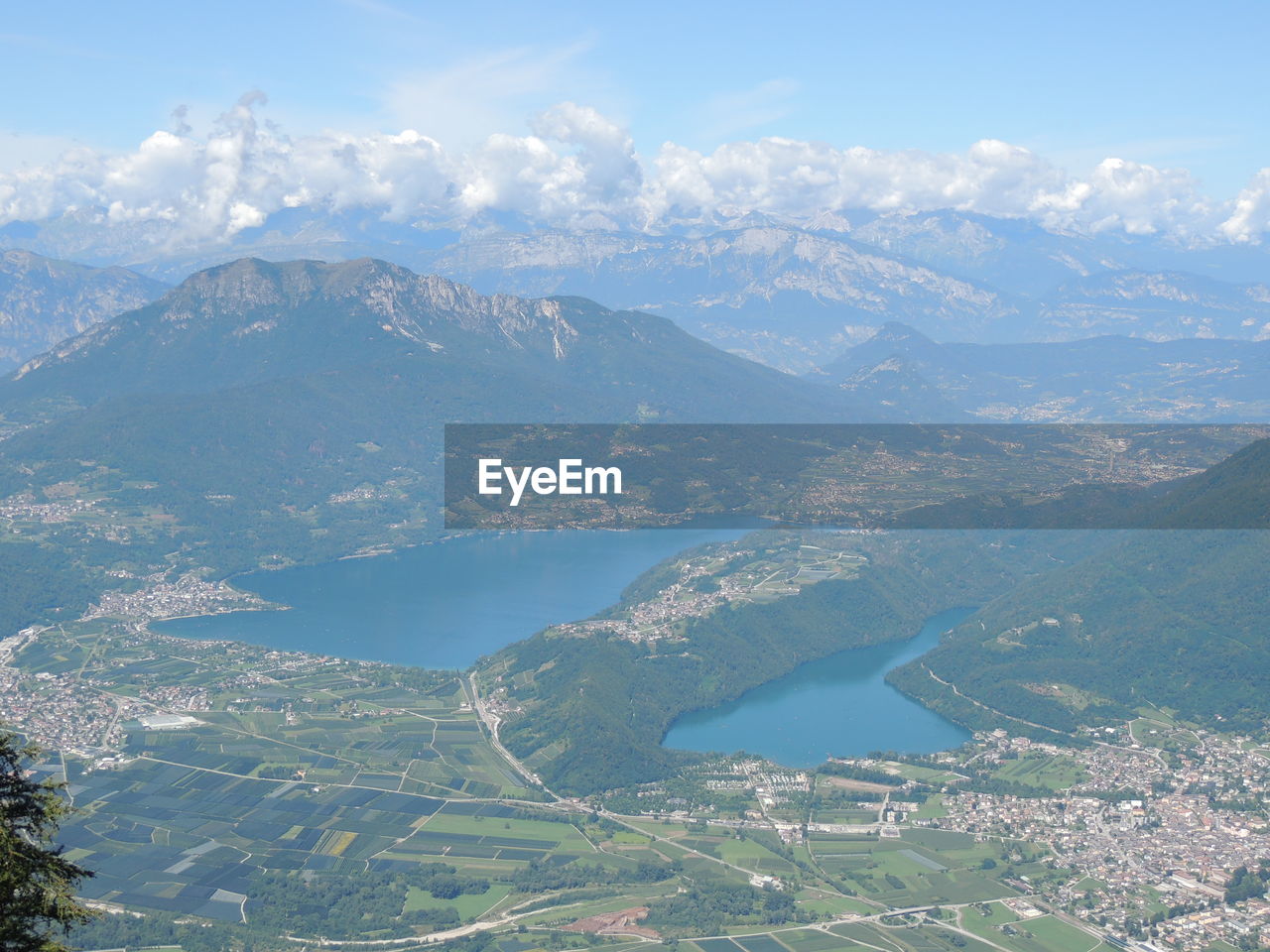 AERIAL VIEW OF CITY BY MOUNTAIN AGAINST SKY