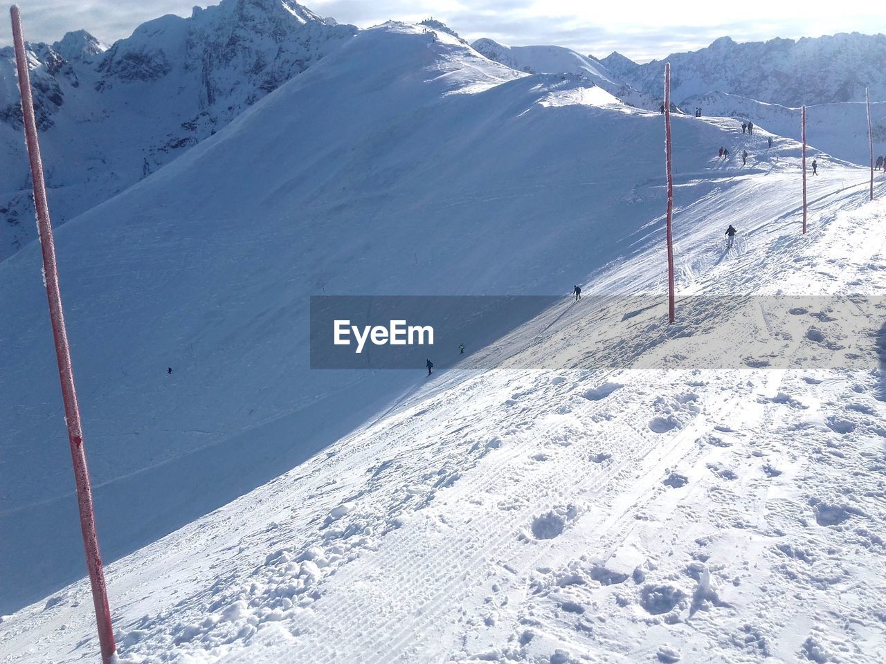 SNOW COVERED LANDSCAPE AGAINST MOUNTAIN RANGE