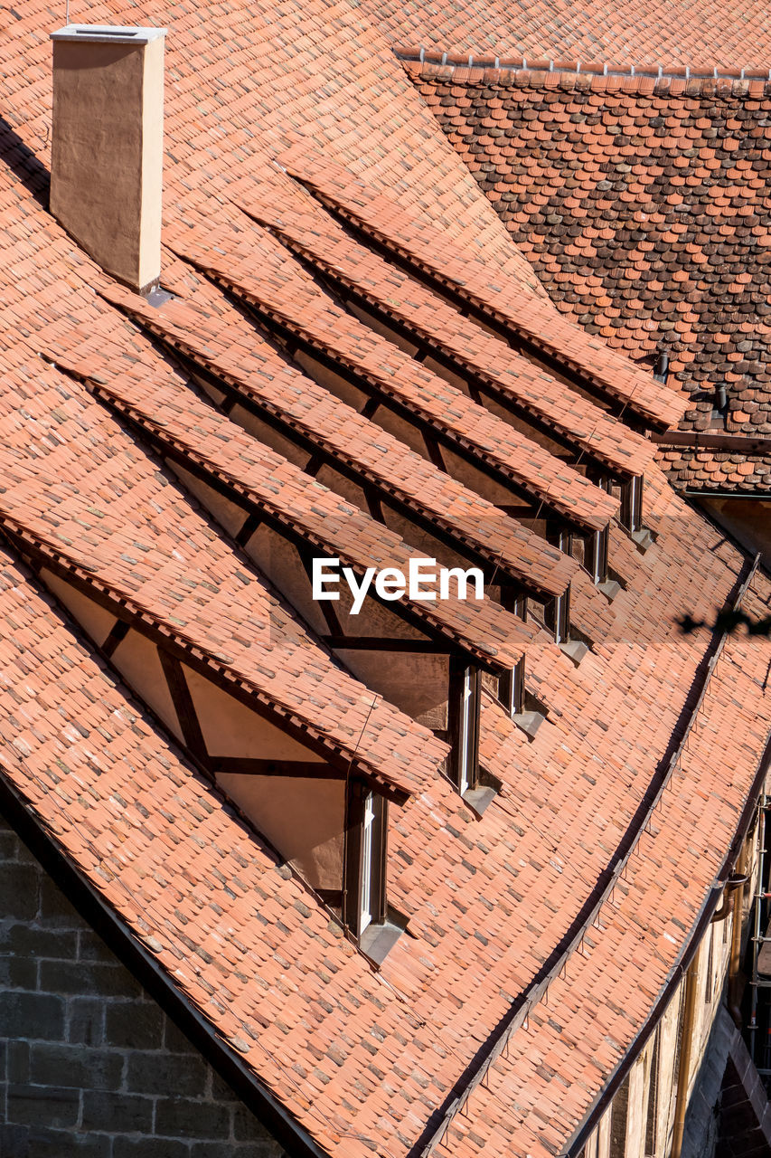 HIGH ANGLE VIEW OF ROOF TILES AND BUILDING