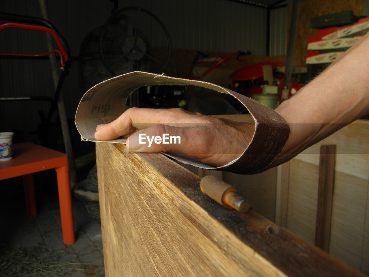 Cropped hand polishing wood
