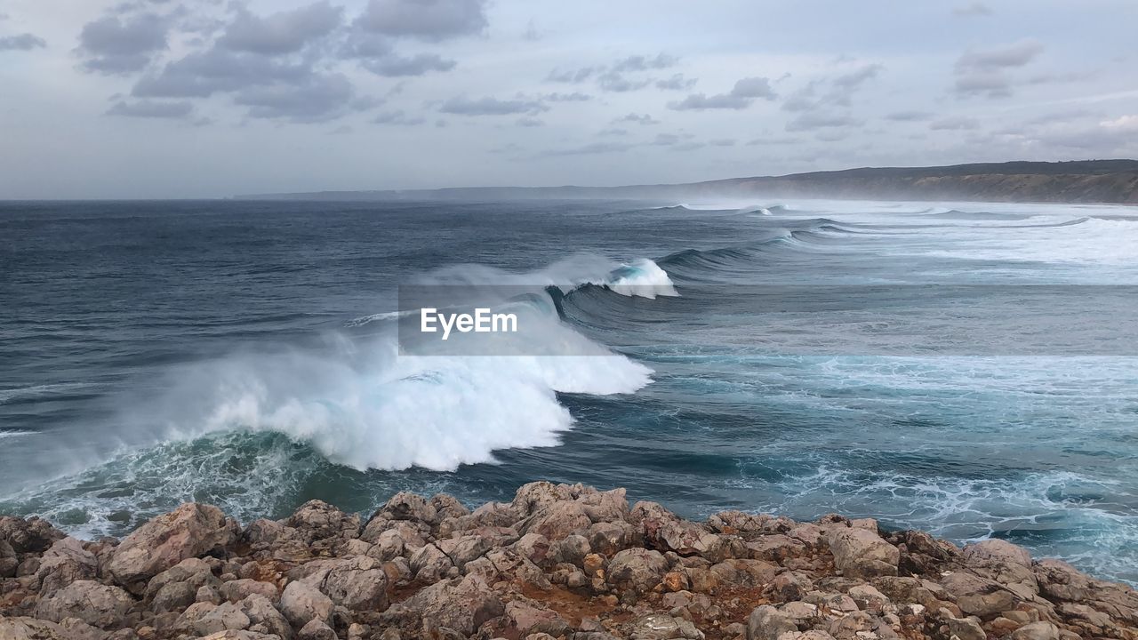 SCENIC VIEW OF SEA WAVES AGAINST SKY