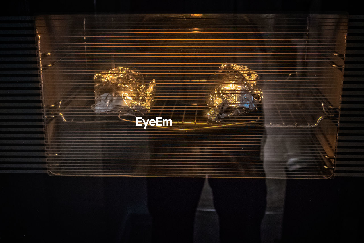 Reflection of person on toaster oven glass in kitchen