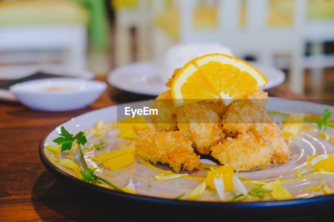 Close-up of orange slice in plate