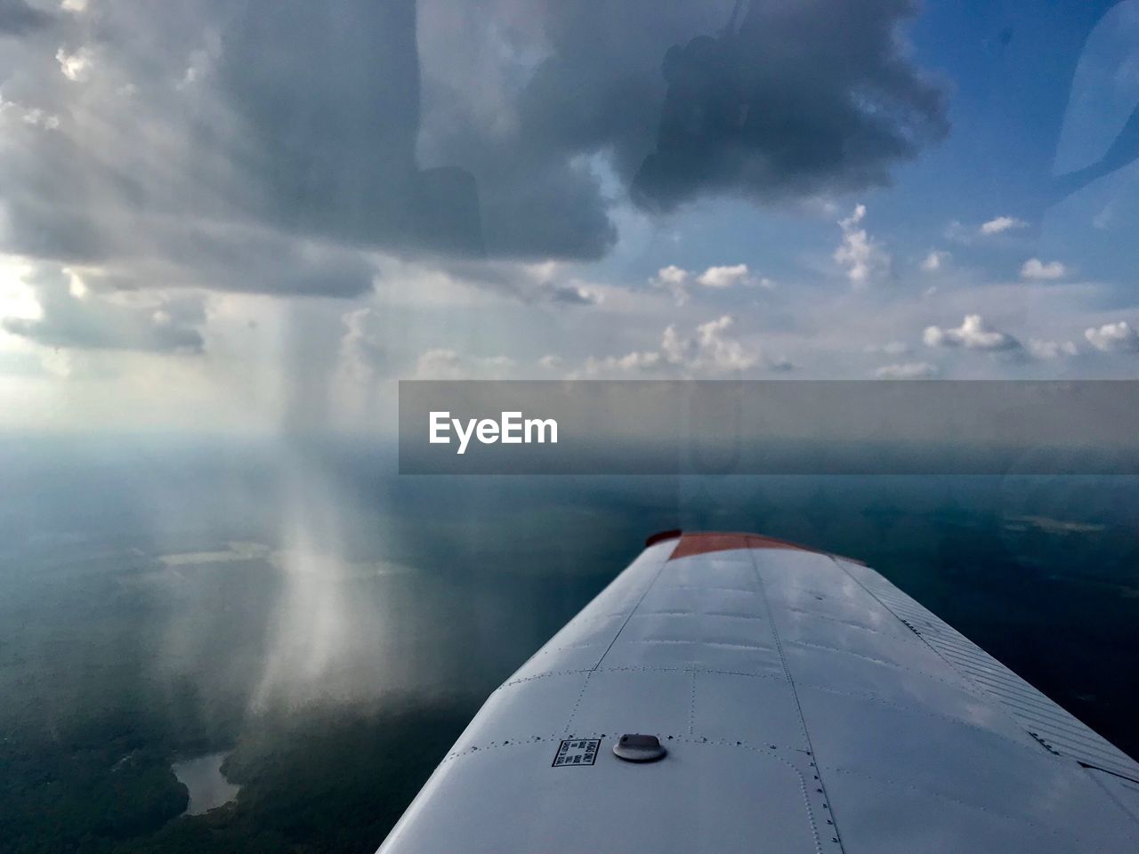 CLOSE-UP OF AIRPLANE WING AGAINST SKY