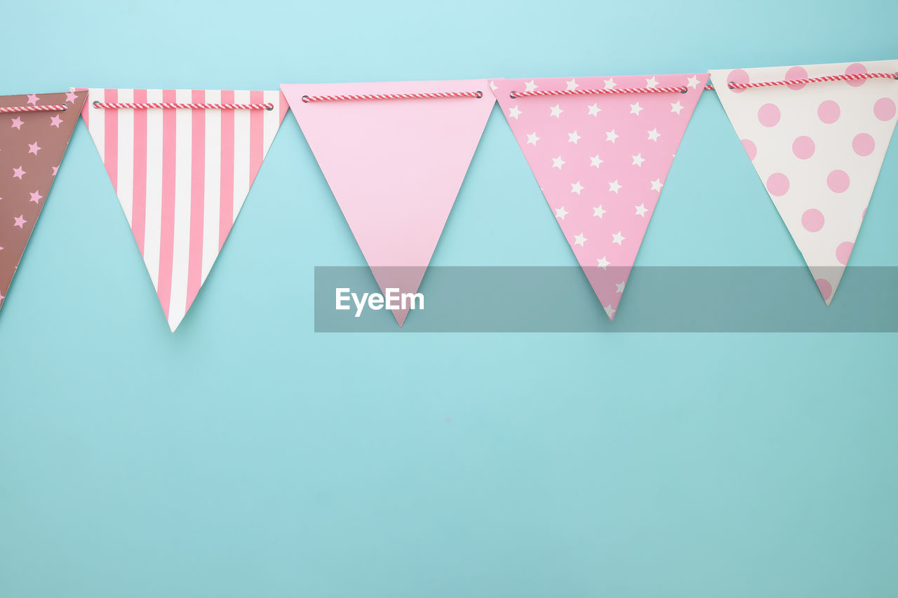 Close-up of buntings against blue background