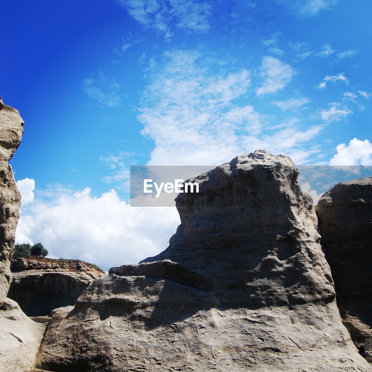 Rock formations against cloudy sky