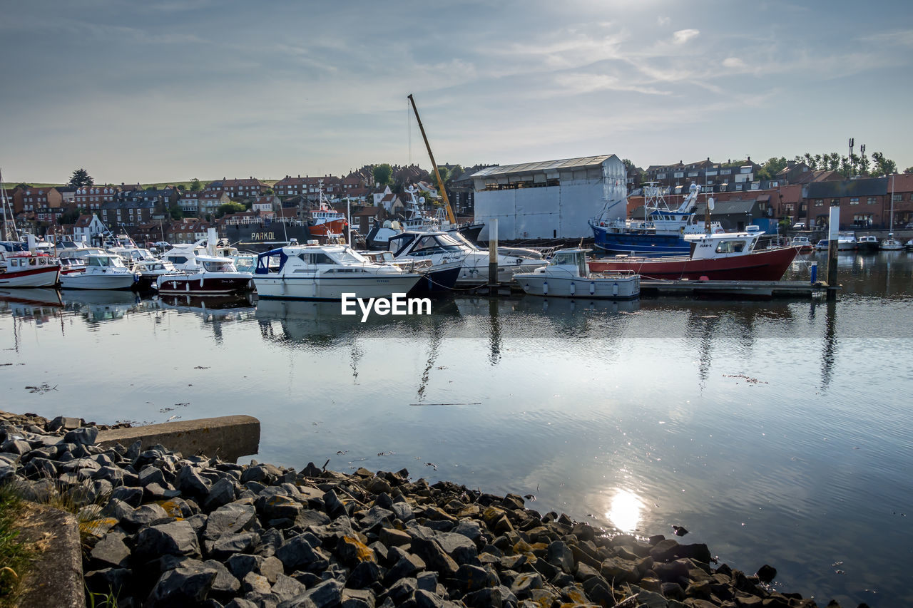 BOATS MOORED IN HARBOR