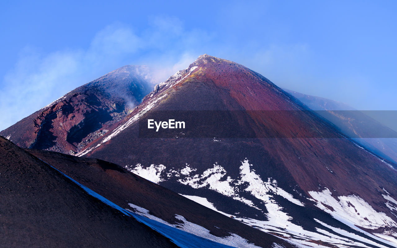 mountain, landscape, volcano, sky, scenics - nature, environment, beauty in nature, stratovolcano, nature, mountain range, snow, travel destinations, ridge, no people, land, cloud, travel, cold temperature, geology, non-urban scene, mountain peak, winter, summit, volcanic landscape, snowcapped mountain, blue, outdoors, day, tourism, tranquility, tranquil scene, cinder cone, transportation