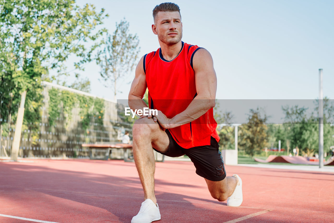 portrait of young man exercising in park