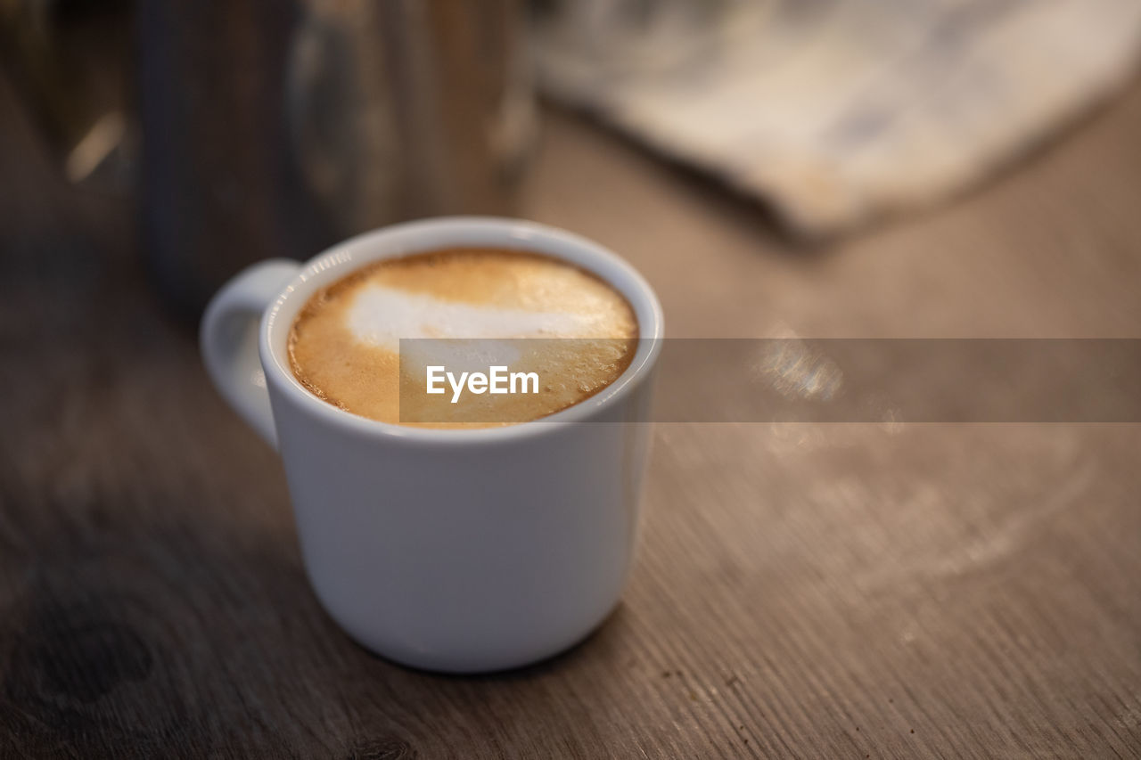 Cappuccino in a cup on a kitchen counter