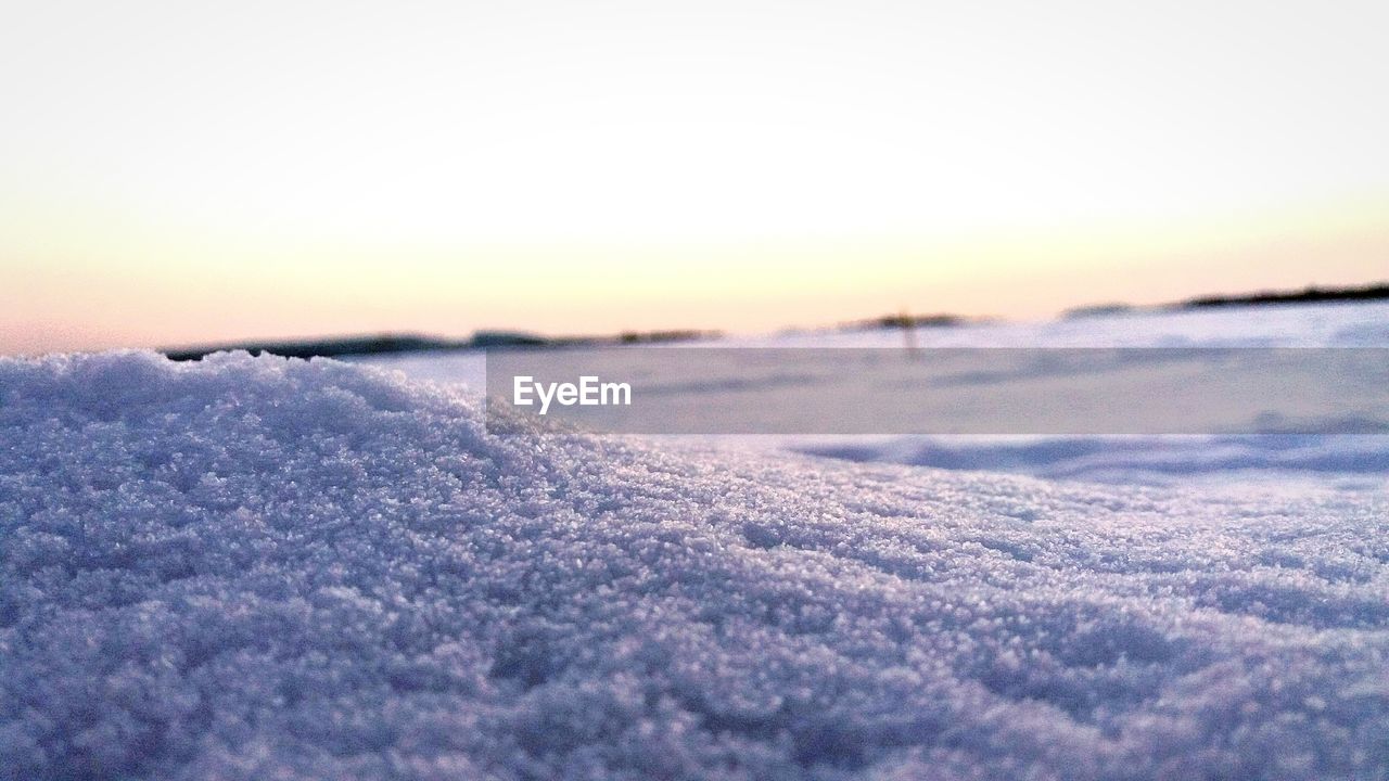 SNOW COVERED LANDSCAPE AGAINST SKY