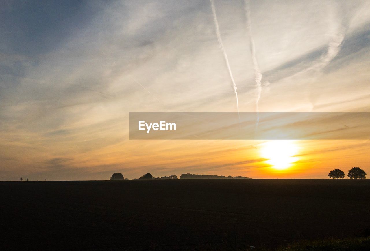 SCENIC VIEW OF SUNSET OVER SILHOUETTE LANDSCAPE