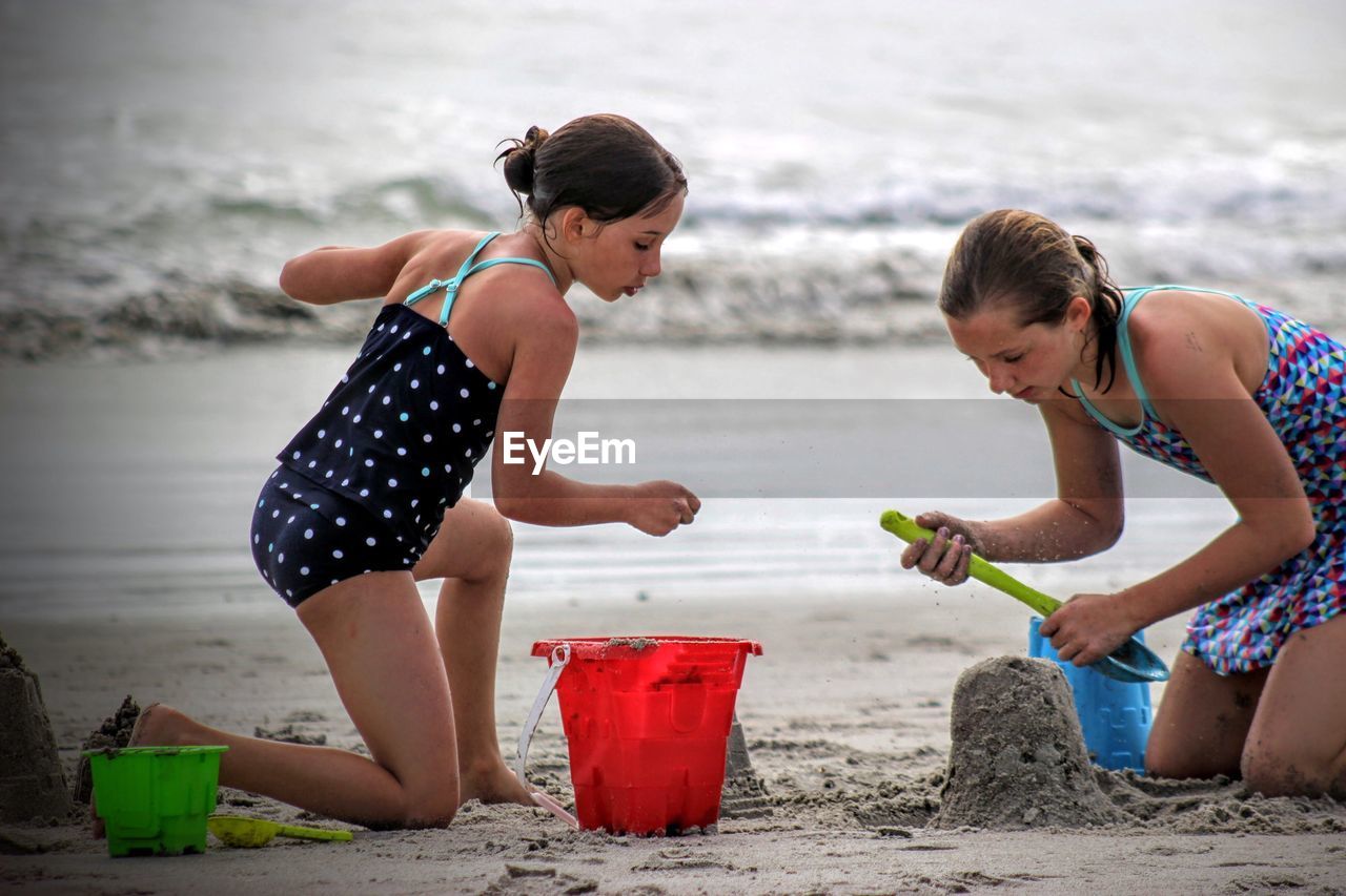 Girls building sandcastle