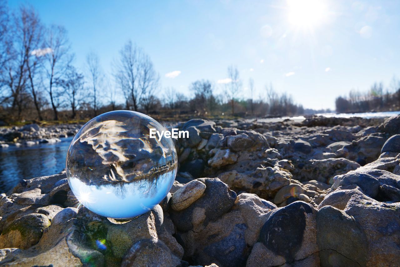 CLOSE-UP OF CRYSTAL BALL ON ROCK IN WINTER