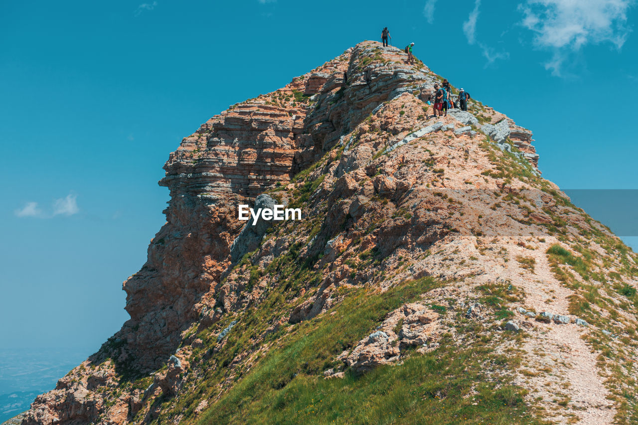 LOW ANGLE VIEW OF ROCK FORMATION AGAINST SKY