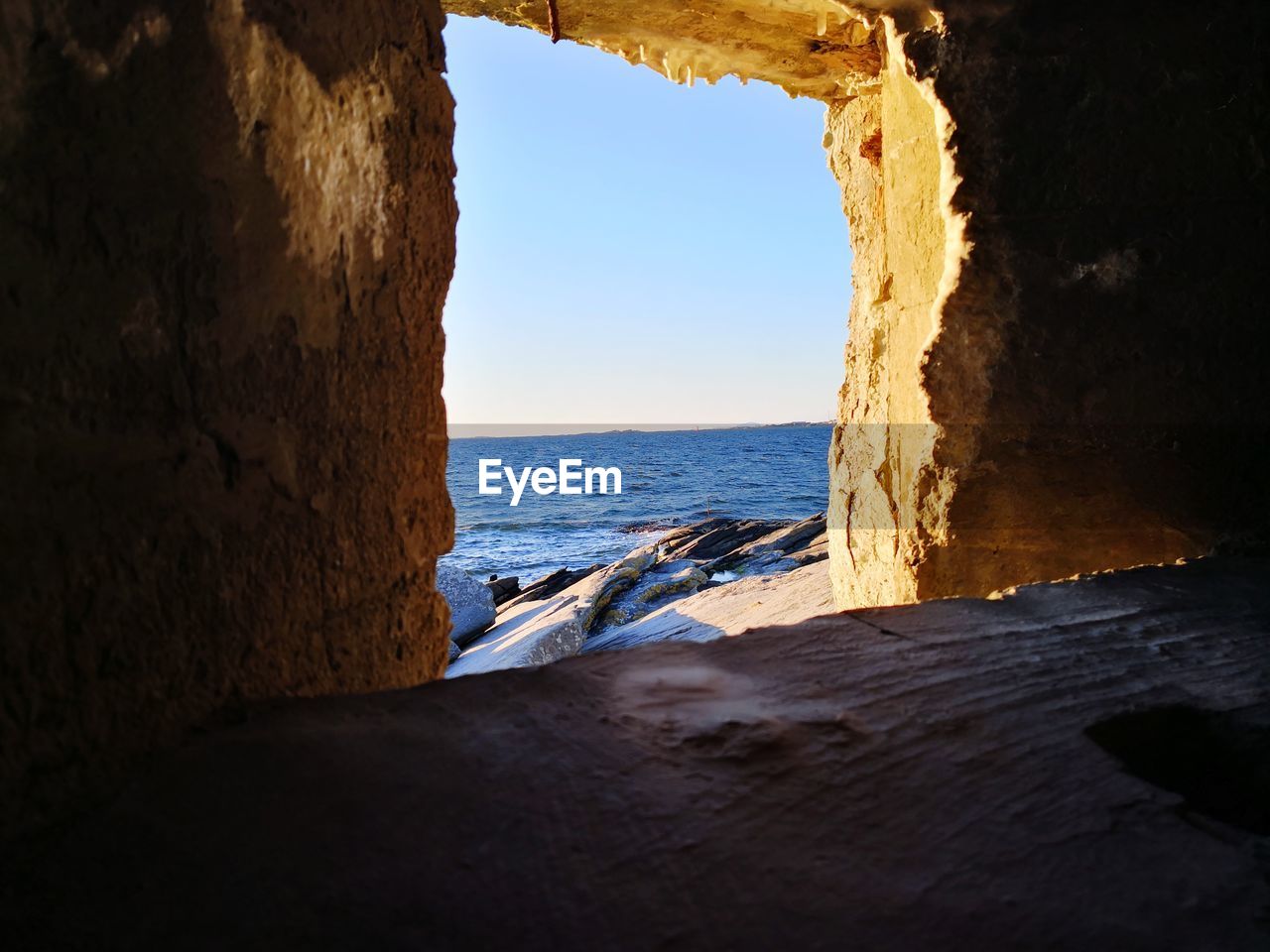 SCENIC VIEW OF SEA SEEN THROUGH CAVE