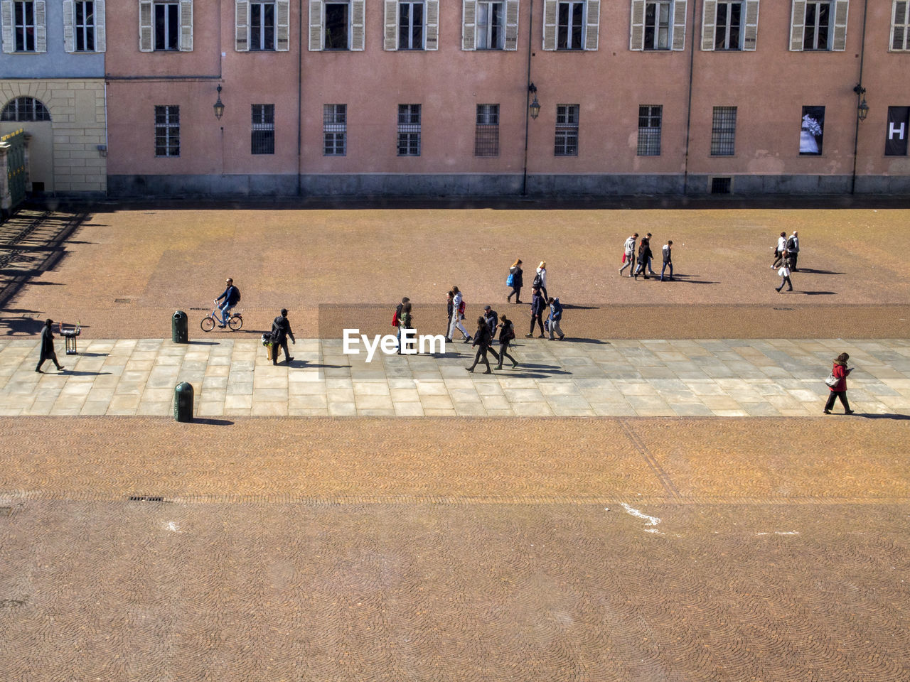 HIGH ANGLE VIEW OF PEOPLE WALKING ON STREET AGAINST BUILDING