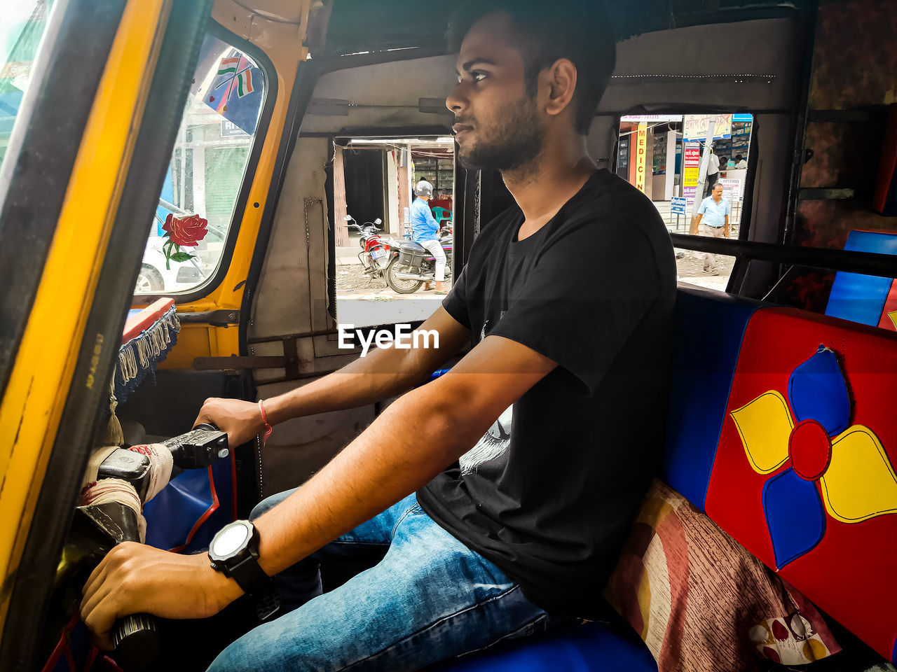 YOUNG MAN LOOKING OUT WHILE SITTING IN BUS
