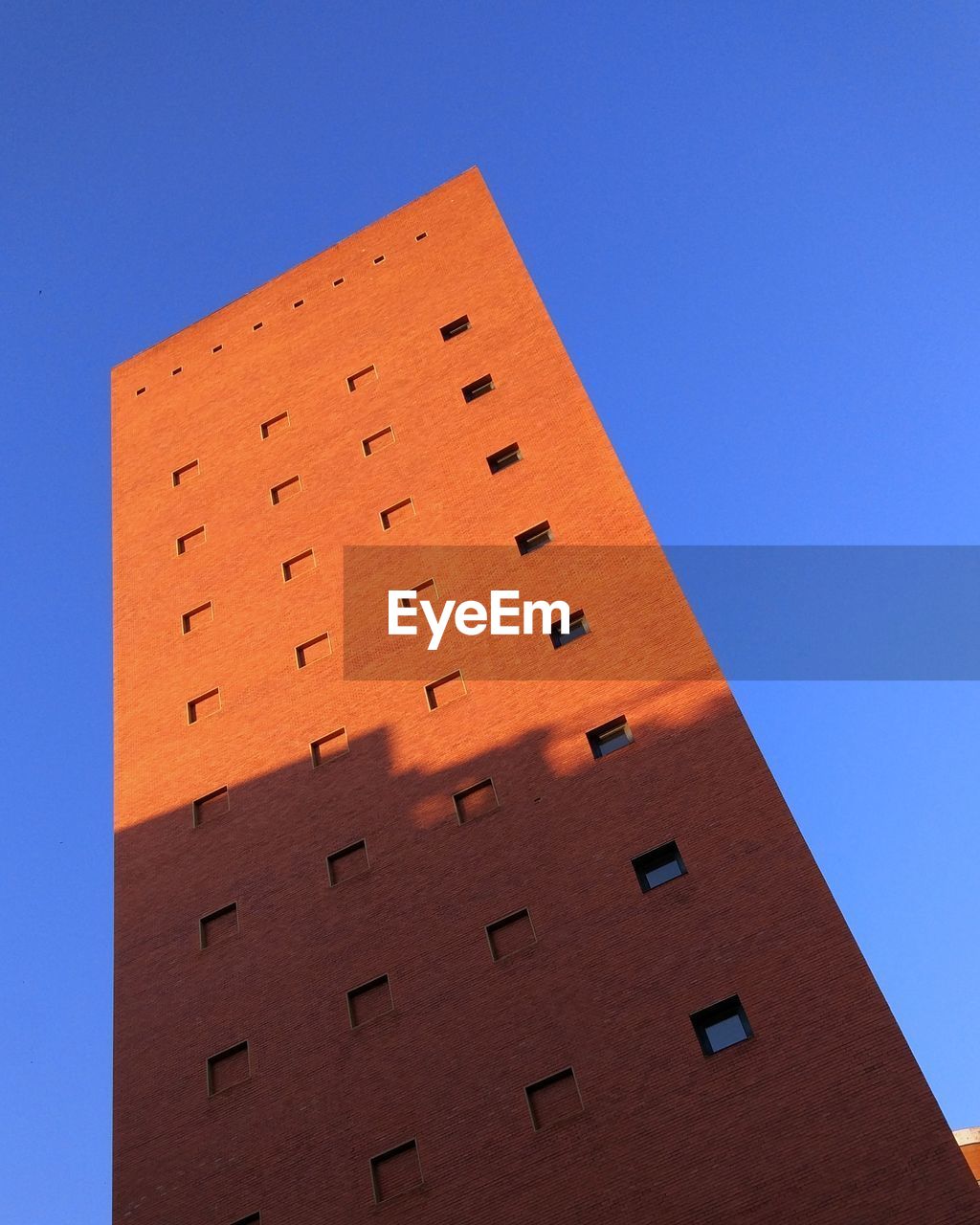 Low angle view of building against clear blue sky