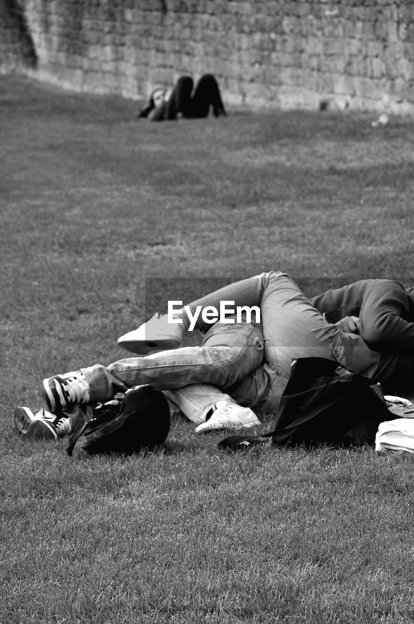 Couple lying on field at park