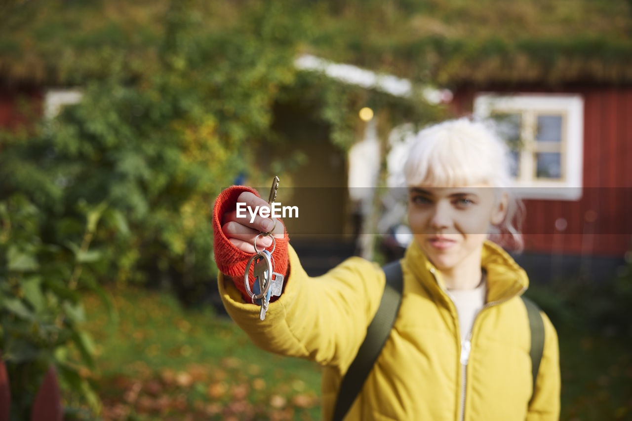 Smiling woman holding house keys