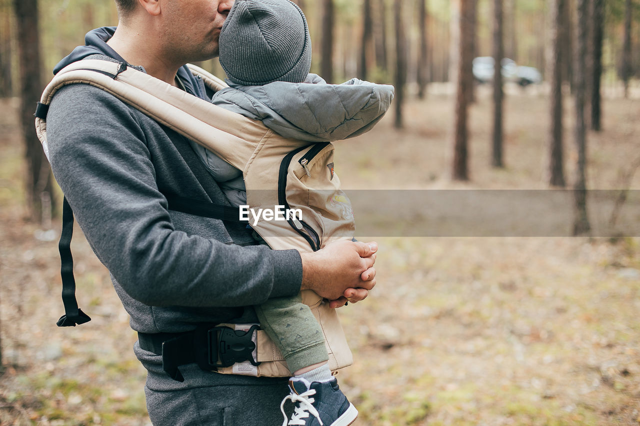 Father and son standing on land