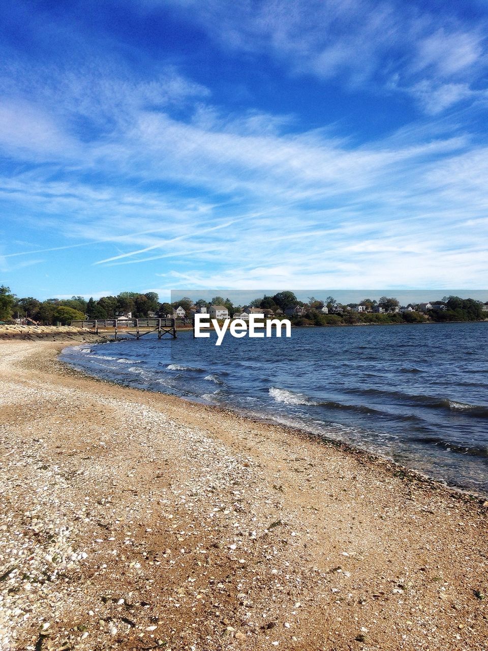 Scenic view of lakeshore against sky