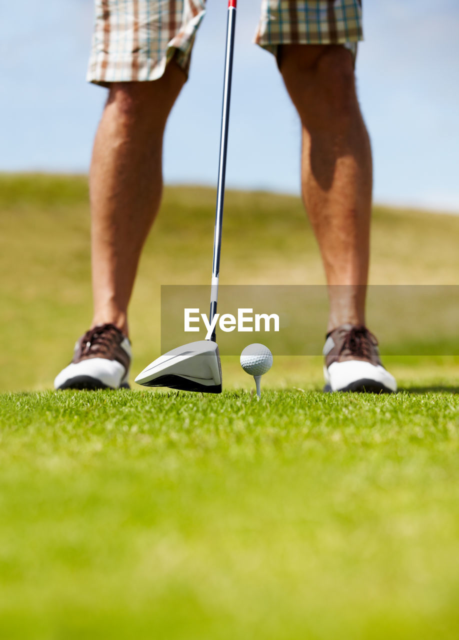 low section of man playing golf