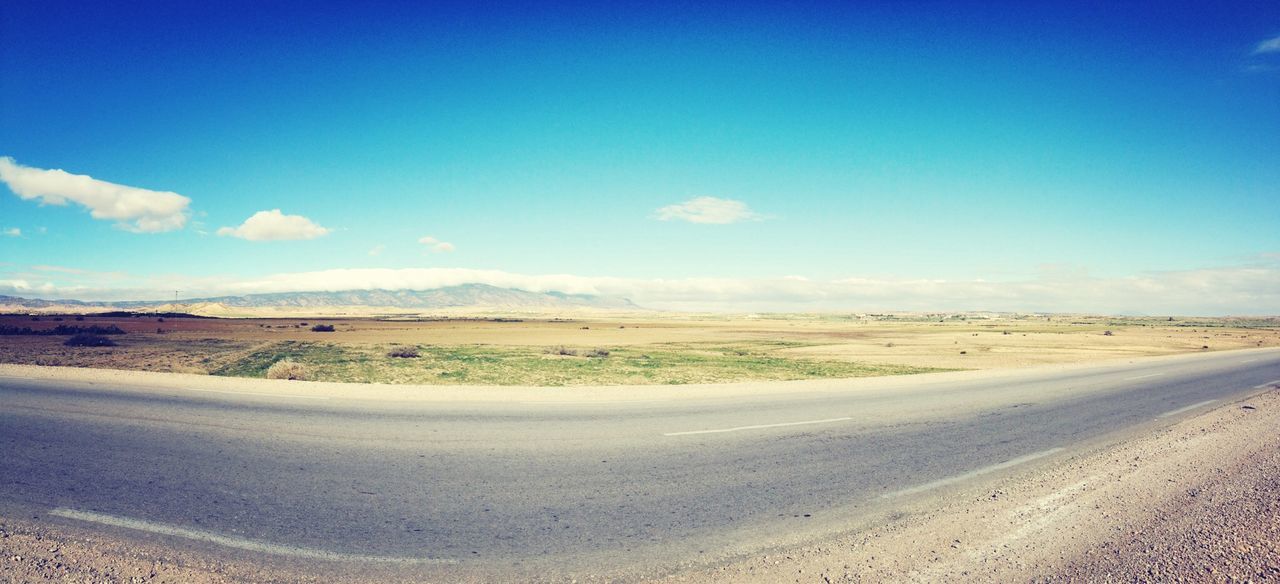 Empty road along countryside landscape