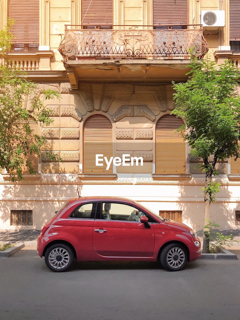 CAR ON STREET AGAINST BUILDINGS