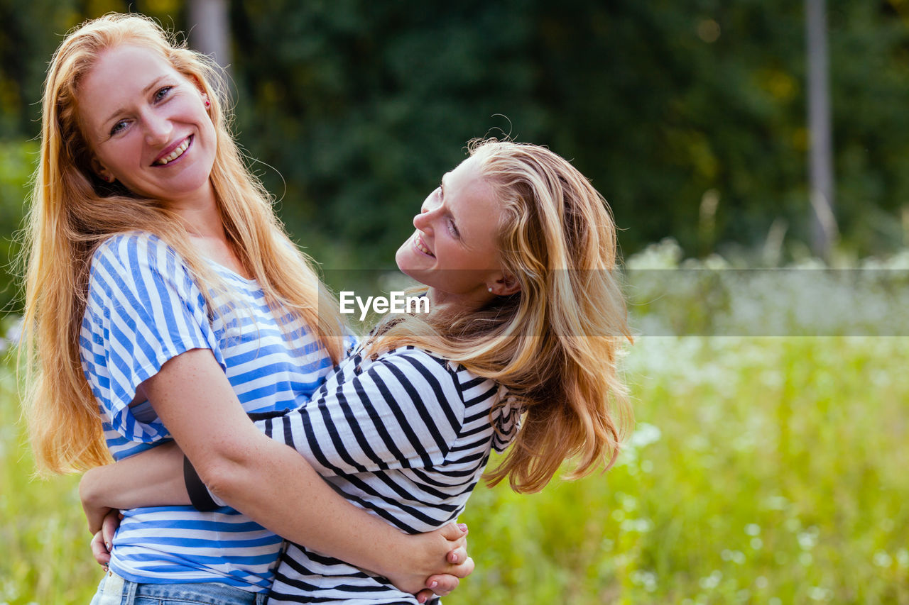 Happy young woman smiling outdoors