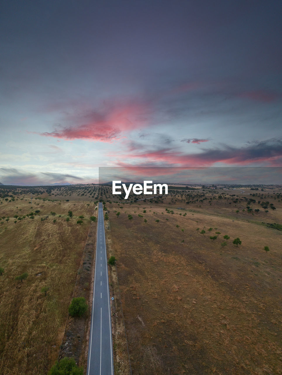 Aerial view of a country road at the sunset.